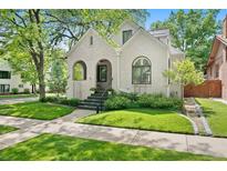 Charming stucco home with a welcoming front porch and manicured lawn at 595 S Race St, Denver, CO 80209