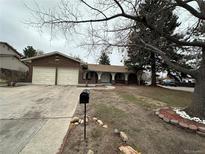 Charming brick ranch home with a two-car garage and covered front porch at 11306 E Colorado Dr, Aurora, CO 80012