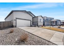 Charming one-story home features a two-car garage, large driveway, and low-maintenance landscaping at 2404 Horse Shoe Cir, Fort Lupton, CO 80621