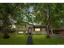 Charming two-story home with beautifully landscaped front yard and mature trees at 3545 Moorhead Ave, Boulder, CO 80305