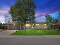 Charming single-story home featuring a well-maintained lawn, large shade tree and an attached two-car garage at 4779 S Owens Way, Littleton, CO 80127