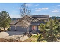 Charming home with a two-car garage, solar panels, and beautiful front yard landscaping and outdoor seating at 481 Sunrise Dr, Golden, CO 80401