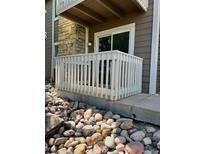 Charming two-story condo exterior with a white picket fence and neutral siding accents at 4400 S Quebec St # 102R, Denver, CO 80237