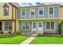 Charming townhome featuring a well-manicured lawn, colorful accents, and a welcoming entryway at 14242 E Hawaii Cir # C, Aurora, CO 80012