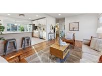 Bright living room with hardwood floors and mid-century modern furniture at 3307 Teller St, Wheat Ridge, CO 80033