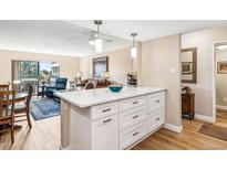 Bright kitchen island with white countertops and storage, seamlessly connected to the living area for open-concept living at 13961 E Marina Dr # 414, Aurora, CO 80014