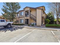 Inviting condo exterior with stone accents, private balcony, reserved parking, and lush landscaping at 4875 S Balsam Way # 6-102, Littleton, CO 80123