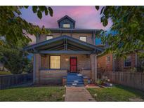 Beautiful two-story brick home with a welcoming front porch and well-manicured lawn at 2854 Eliot St, Denver, CO 80211