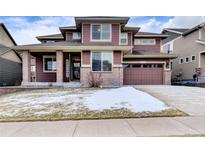 Two-story house with brick and siding, attached garage, and landscaping at 20830 Scenic Park Dr, Parker, CO 80138
