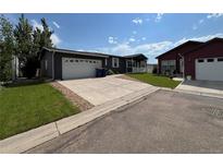 Charming home featuring a well-maintained lawn and an attached two-car garage at 6100 Bluestem # 238, Frederick, CO 80530