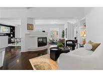 Bright living room featuring hardwood floors, a modern fireplace, and contemporary furnishings at 1940 Blake St # 300, Denver, CO 80202