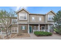 Charming townhome with a welcoming front porch, manicured landscaping, and a well-maintained exterior at 14700 E 104Th Ave # 1602, Commerce City, CO 80022