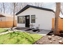 View of the home's exterior, highlighting the well-maintained lawn and modern black and white color scheme at 3728 W Exposition Ave, Denver, CO 80219