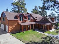 Charming two-story home featuring wood siding, a covered porch and well-maintained landscaping at 21531 Main Ave, Golden, CO 80401