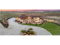 Expansive estate boasting meticulous landscaping, and impressive stone and stucco detailing at 12565 Picadilly Rd, Commerce City, CO 80022
