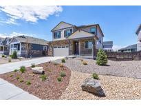 Charming two-story home features a well-manicured, low-maintenance front yard and attached two-car garage at 9 N Waterloo St, Aurora, CO 80018