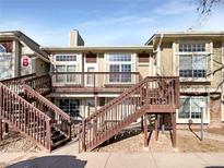 Attractive exterior of a two-story townhome with wooden stairs and deck at 1885 S Quebec Way # B23, Denver, CO 80231