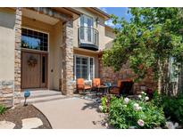 Charming front porch with stone accents, seating, and a welcoming entrance with floral wreath at 11433 Decatur Ct, Westminster, CO 80234
