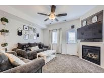 Cozy living room with fireplace, neutral tones, and stylish decor for a relaxing ambiance at 2235 Coronado Pkwy # A, Denver, CO 80229