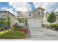 Charming two-story home featuring a covered porch, a two-car garage, and well-maintained landscaping at 8926 Swan River St, Littleton, CO 80125