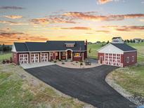 Inviting exterior features a long driveway, and a lovely home and detached garage with matching red and white doors at 3124 Antelope Ridge Trl, Parker, CO 80138