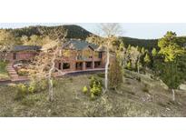 Brick home with large windows and mountain views at 26269 Richmond Hill Rd, Conifer, CO 80433