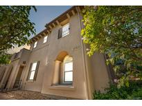 Charming stucco home with architectural details and landscaped front yard, featuring prominent address display at 22933 E Ontario Dr # 105, Aurora, CO 80016