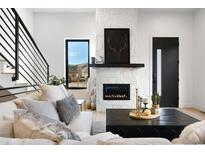 Bright living room with a stone fireplace, modern black windows, and a comfortable sectional sofa at 19 Washington Ave, Golden, CO 80403