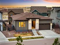 Charming one-story home with a well-manicured front yard and a two-car garage at 6530 Barnstead Dr, Castle Pines, CO 80108