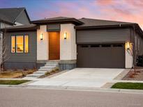 Inviting single-Gathering home featuring modern design, brick accents, and a spacious driveway at 6530 Barnstead Dr, Castle Pines, CO 80108