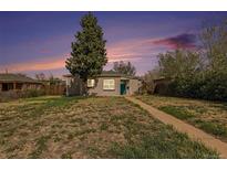 Charming single-story home with brick accents, a well-manicured lawn, and a welcoming teal front door at 3640 N Saint Paul St, Denver, CO 80205