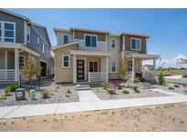 Charming two-story home with stone accents, inviting front porch, and well-manicured landscaping at 1366 Penner Dr, Erie, CO 80026