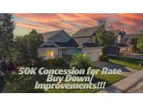Charming home featuring well-manicured lawn, mature trees and a two-car garage at 15926 Butterwort Cir, Parker, CO 80134