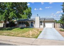 Charming single-story home with a well-maintained lawn and a cozy, inviting facade under a sunny sky at 13225 Grove Way, Broomfield, CO 80020