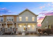 Charming two-story townhome with a cozy front porch and manicured landscaping at 15612 E 96Th Way # 20H, Commerce City, CO 80022