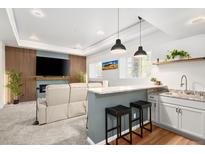 Finished basement featuring a bar area, media center, and an electric fireplace at 25362 E Indore Dr, Aurora, CO 80016