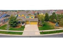 An aerial view of a two-story home with a three-car garage and well-maintained lawn at 25362 E Indore Dr, Aurora, CO 80016