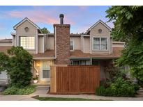 Inviting townhome featuring a well-maintained front yard, brick chimney, and neutral siding at 12142 Bannock Cir # B, Denver, CO 80234