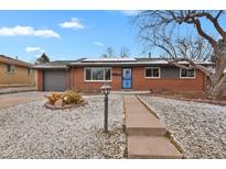 Charming brick home with a well-maintained front yard and a lovely walkway leading to the front door at 2354 S Stuart St, Denver, CO 80219