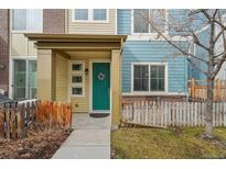 Charming two-story home with a welcoming teal-colored front door and cozy porch at 2212 Tamarac St, Denver, CO 80238