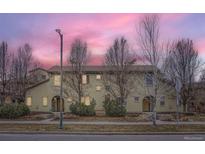 Charming townhouse showcasing its neutral color and detailed architecture surrounded by manicured landscaping at 10148 E 29Th Dr, Denver, CO 80238