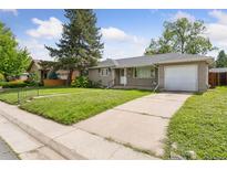 Charming single-story home with a well-maintained lawn and a driveway leading to an attached garage at 1742 S Forest St, Denver, CO 80222