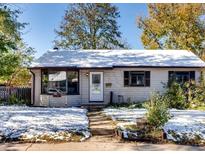 Charming ranch home with snow-covered yard at 5191 S Pennsylvania St, Littleton, CO 80121