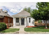 Charming cottage-style home with a cozy front porch and well-maintained lawn at 3365 S Grant St, Englewood, CO 80113