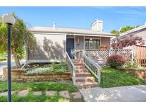 Inviting home featuring a well-maintained front yard, brick stairs, and a charming covered porch at 3853 S Genoa Ct # D, Aurora, CO 80013