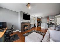 Comfortable living room features a fireplace and an open layout at 9059 E Panorama Cir # B306, Englewood, CO 80112