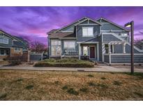 Charming townhome with well-maintained front yard and inviting entry; beautiful sunset sky at 14300 Waterside Ln # J4, Broomfield, CO 80023