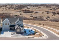Charming two-story home with stone accents and attached garage located on a cul-de-sac at 7517 Copper Sky Ct, Castle Pines, CO 80108