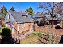 Charming two-story brick home featuring a quaint brick courtyard, mature trees, and a classic architectural style at 210 S High St, Denver, CO 80209