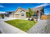 Charming home featuring well-manicured lawn and a quaint front porch area perfect for enjoying the outdoors at 56459 E 23Rd Pl, Strasburg, CO 80136